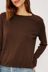 Brown sweater worn by a person on a white background