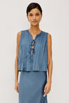 model wearing blue tie front sleeveless top with matching satin skirt 