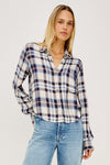 model wearing checkered short shirt with light blue denim jeans on a white background