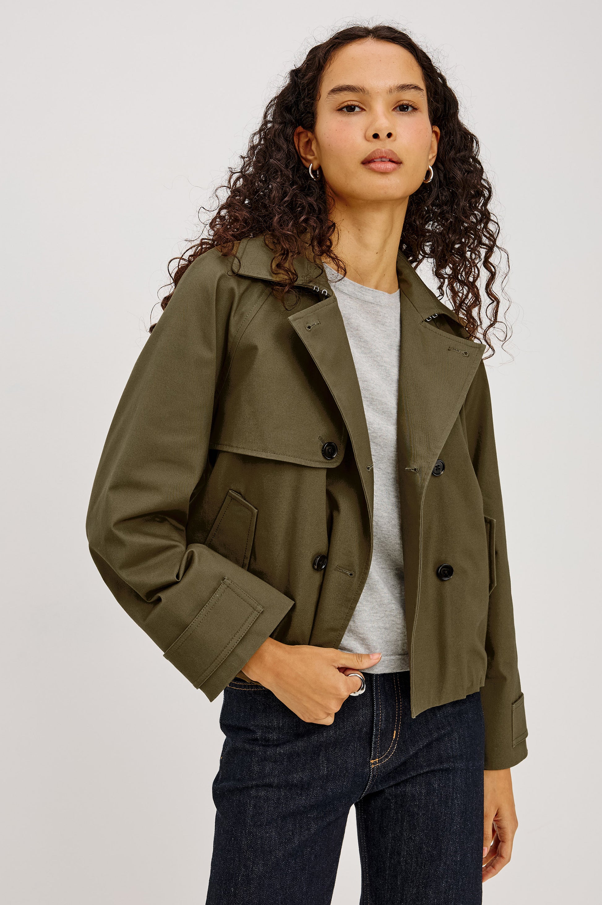 khaki green double breasted jacket worn with dark denim jeans 