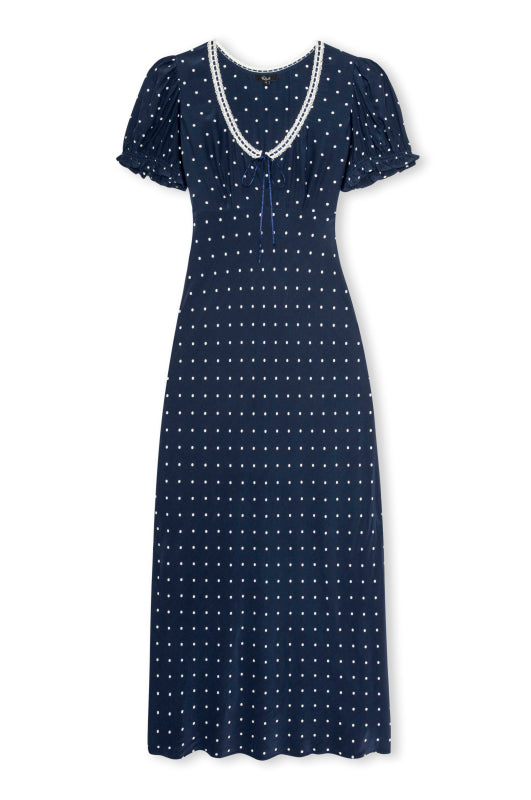 A navy blue midi dress with a white polka dot pattern, featuring short flutter sleeves and a V-neckline accented with a white lace trim.