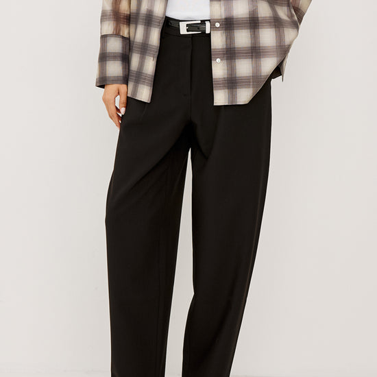 black trousers worn with a kitten heel and a checked shirt