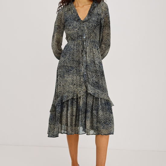Blue ditsy print dress with long sleeves and v neck worn with a kitten heel