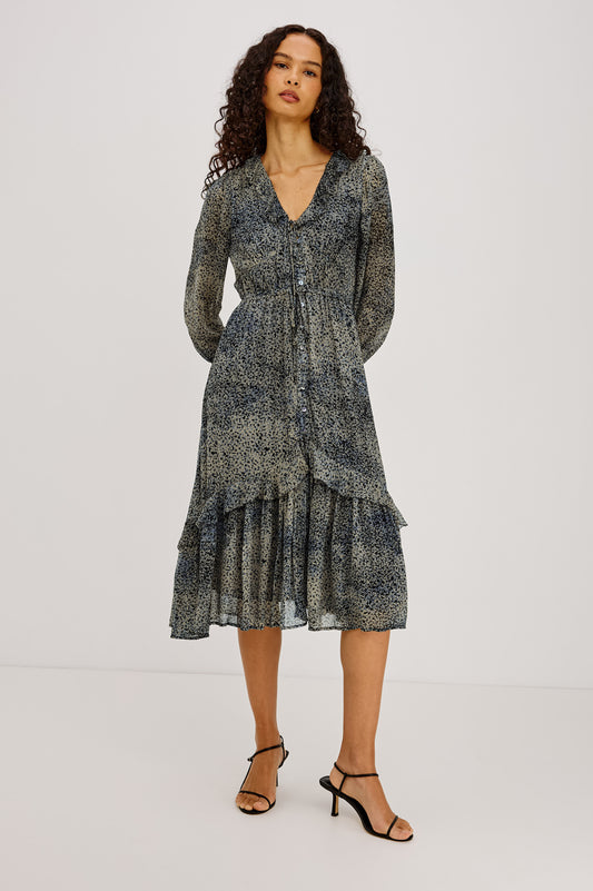 Blue ditsy print dress with long sleeves and v neck worn with a kitten heel