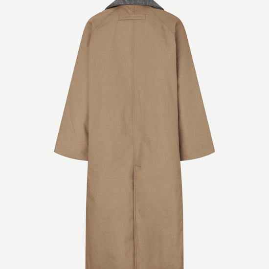 Beige trench coat on a white background