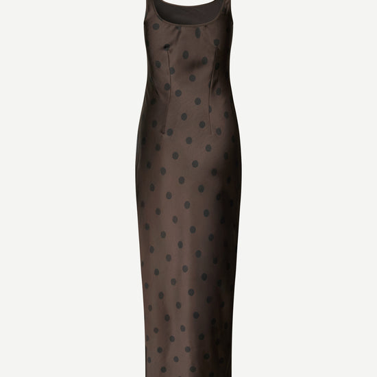 A dark brown satin slip dress with a black polka dot pattern, shown on a plain light gray background.