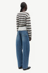 model wearing striped boat neck jumper and jeans on white background rear view