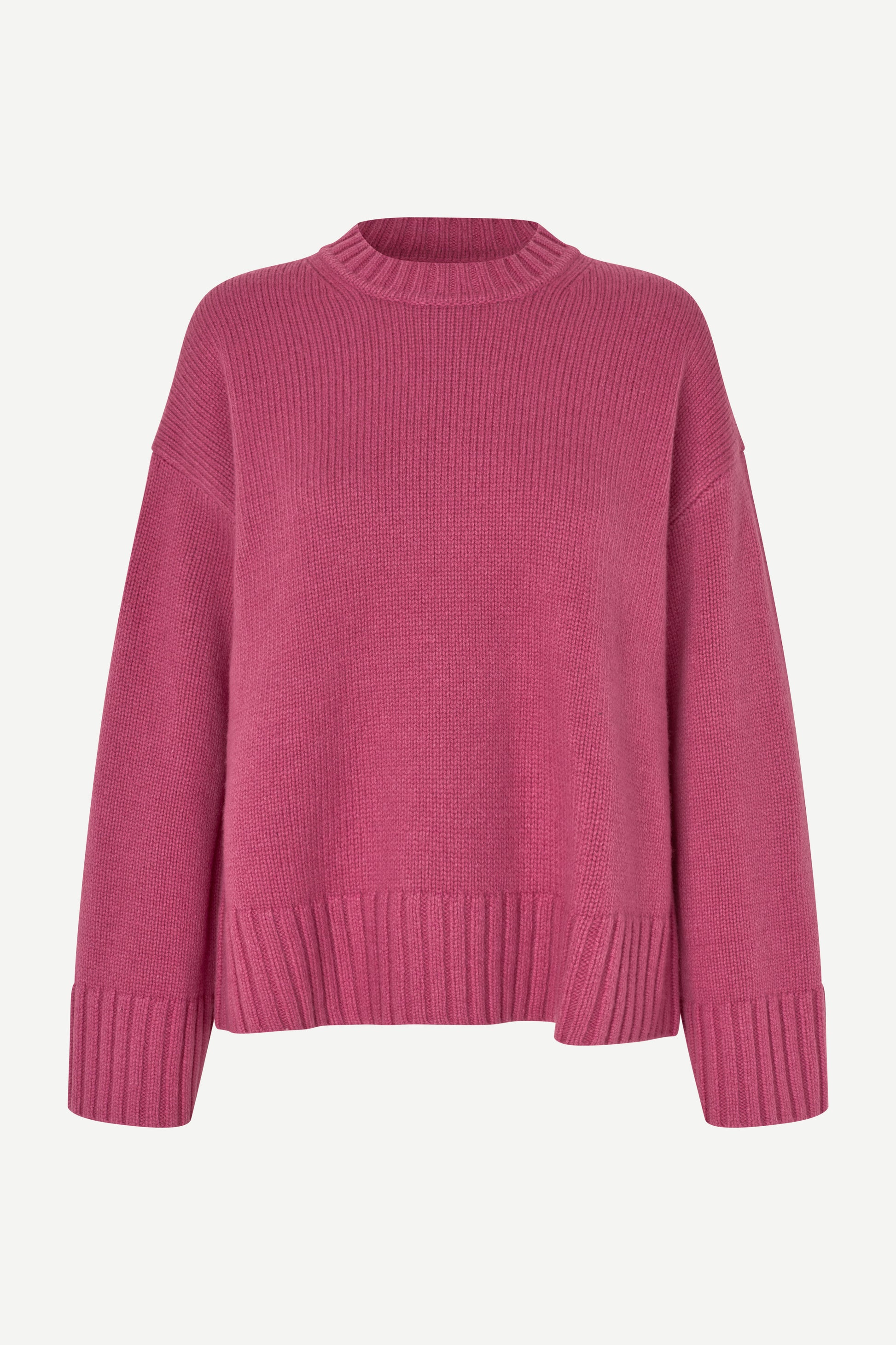 A pink ribbed knit crewneck sweater with dropped shoulders and ribbed cuffs, displayed on a clean off-white background.