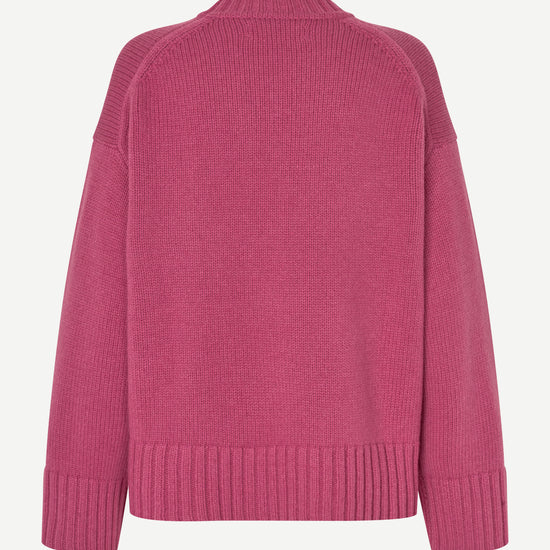 A pink knit sweater shown from the back, featuring a crew neck, raglan sleeves, and ribbed cuffs and hem, displayed on a clean white background.