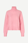A light pink knit turtleneck sweater displayed on a clean, light gray background.