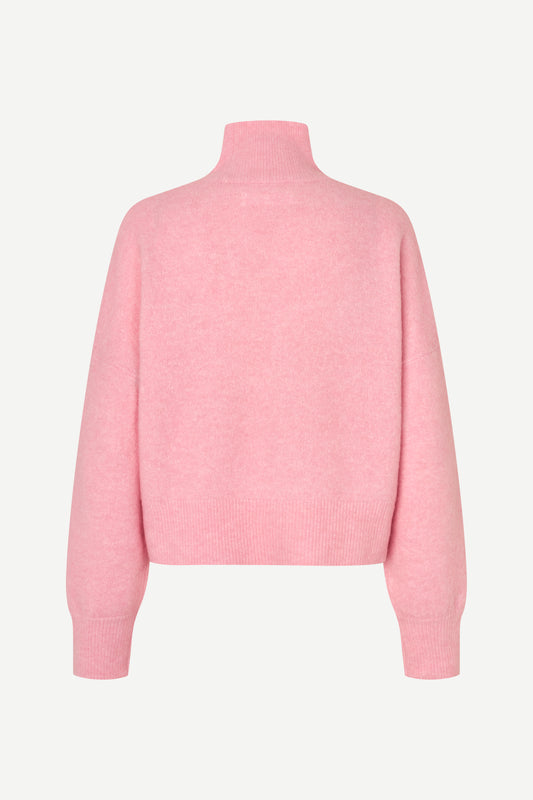 A light pink knit sweater with a mock neck and long sleeves, shown from the back on a clean, light off-white background.