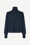 A dark navy blue knit turtleneck sweater with long sleeves, shown from the back on a light gray background.