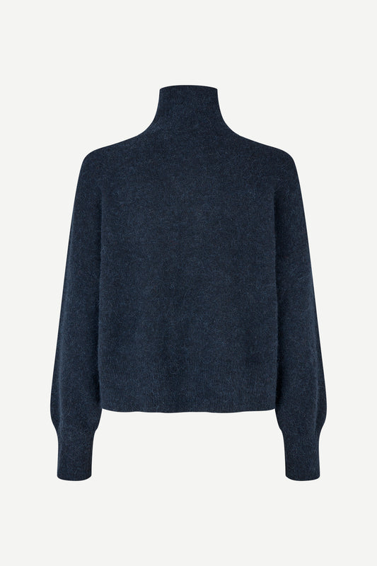 A dark navy blue knit turtleneck sweater with long sleeves, shown from the back on a light gray background.