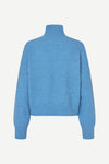 A light blue knit mock neck sweater shown from the back, featuring long sleeves and ribbed cuffs and hem, set against a plain off-white background.