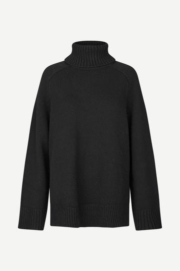 A black ribbed-knit turtleneck sweater with raglan sleeves, shown against a plain light gray background.