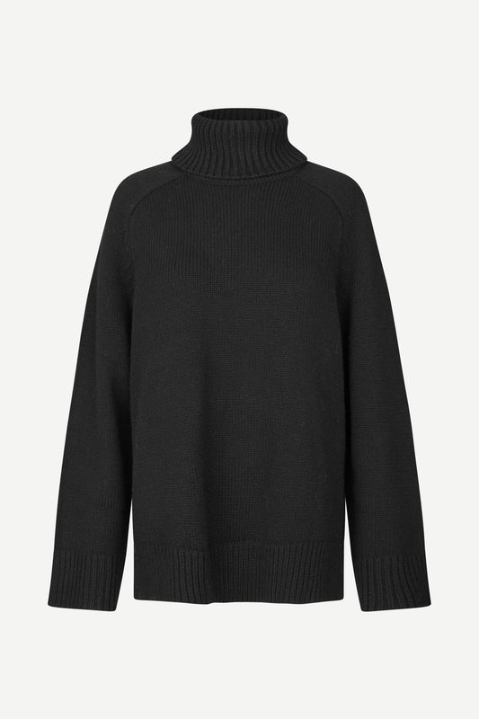 A black ribbed-knit turtleneck sweater with raglan sleeves, shown against a plain light gray background.