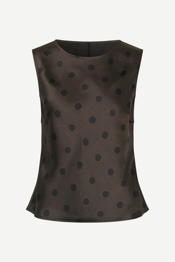 Brown sleeveless top with black polka dots on a white background