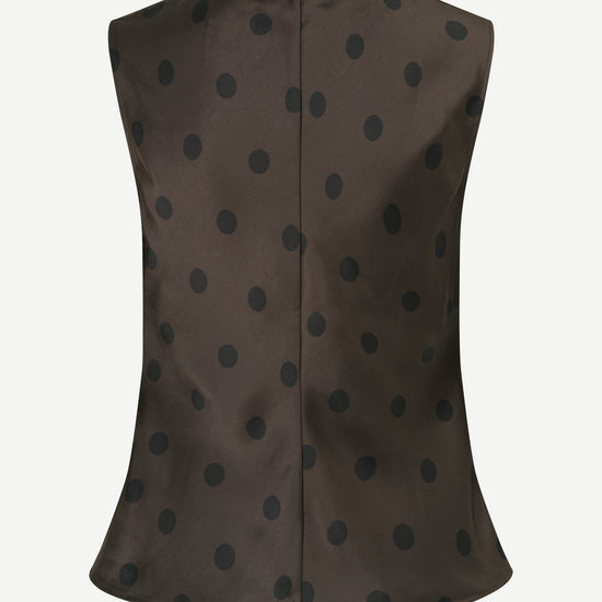 A sleeveless dark brown vest with a black polka dot pattern, shown from the back against a light gray background.