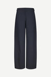 A pair of dark navy wide-leg trousers shown from the back on a light gray background.