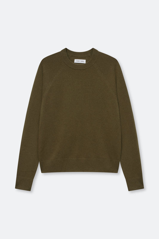 An olive green crewneck sweater with raglan sleeves, laid flat against a light gray background.