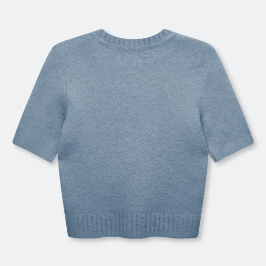 A light blue short-sleeve knit sweater shown from the back, featuring a crew neck and ribbed hem, on a light gray background.
