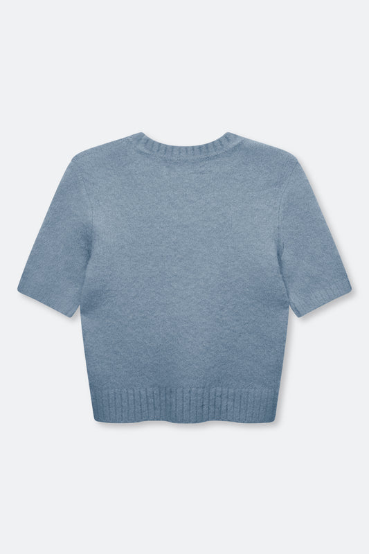 A light blue short-sleeve knit sweater shown from the back, featuring a crew neck and ribbed hem, on a light gray background.
