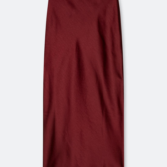 A dark burgundy midi skirt with a subtle sheen, laid flat against a light gray background.