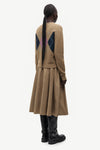woman wearing brown pink and blue argyle cardigan on white background rear view