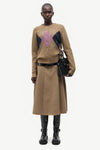 woman wearing brown pink and blue argyle cardigan on white background full outfit