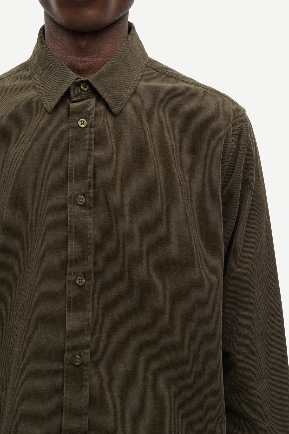 Close up of man wearing green cord shirt