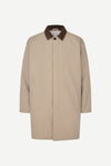 A beige trench coat with a contrasting dark brown corduroy collar, shown against a plain light gray background.