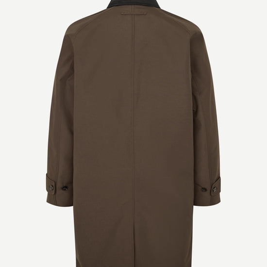 A dark brown longline coat shown from the back, featuring a black collar and button details on the cuffs, set against a plain light gray background.