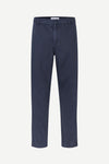 A pair of navy blue straight-leg trousers shown flat against a light gray background.