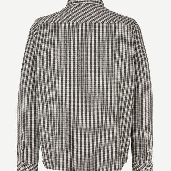 A long-sleeve button-up shirt with a black and white checkered pattern, shown from the back on a light gray background.