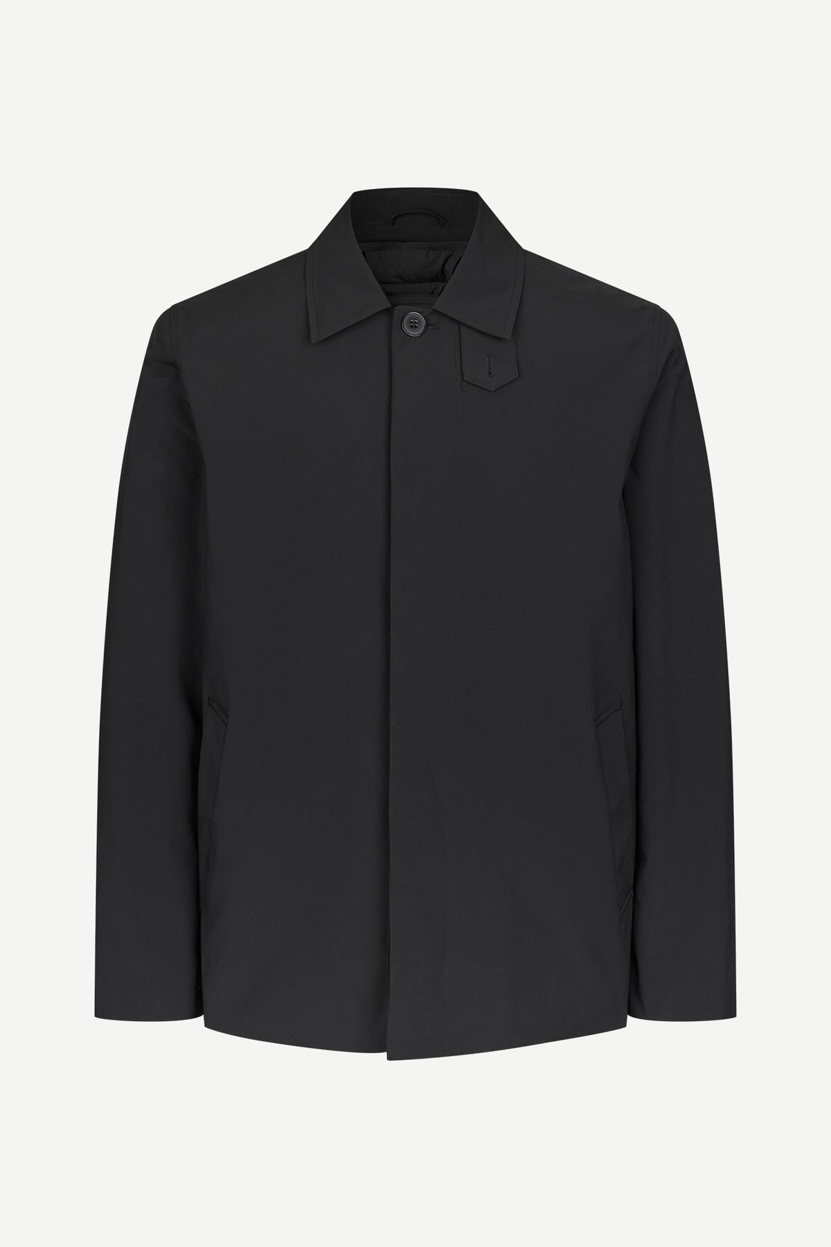 A black long-sleeve utility jacket with a pointed collar and a single button closure, displayed on a clean, light gray background.