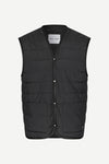 A black sleeveless puffer vest with horizontal quilting, snap-button front, and two front patch pockets, shown flat against a light gray background.