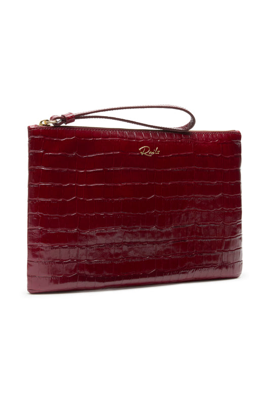 A deep burgundy crocodile-embossed leather clutch with a matching wristlet strap and a small gold-tone logo on the front, set against a plain white background.