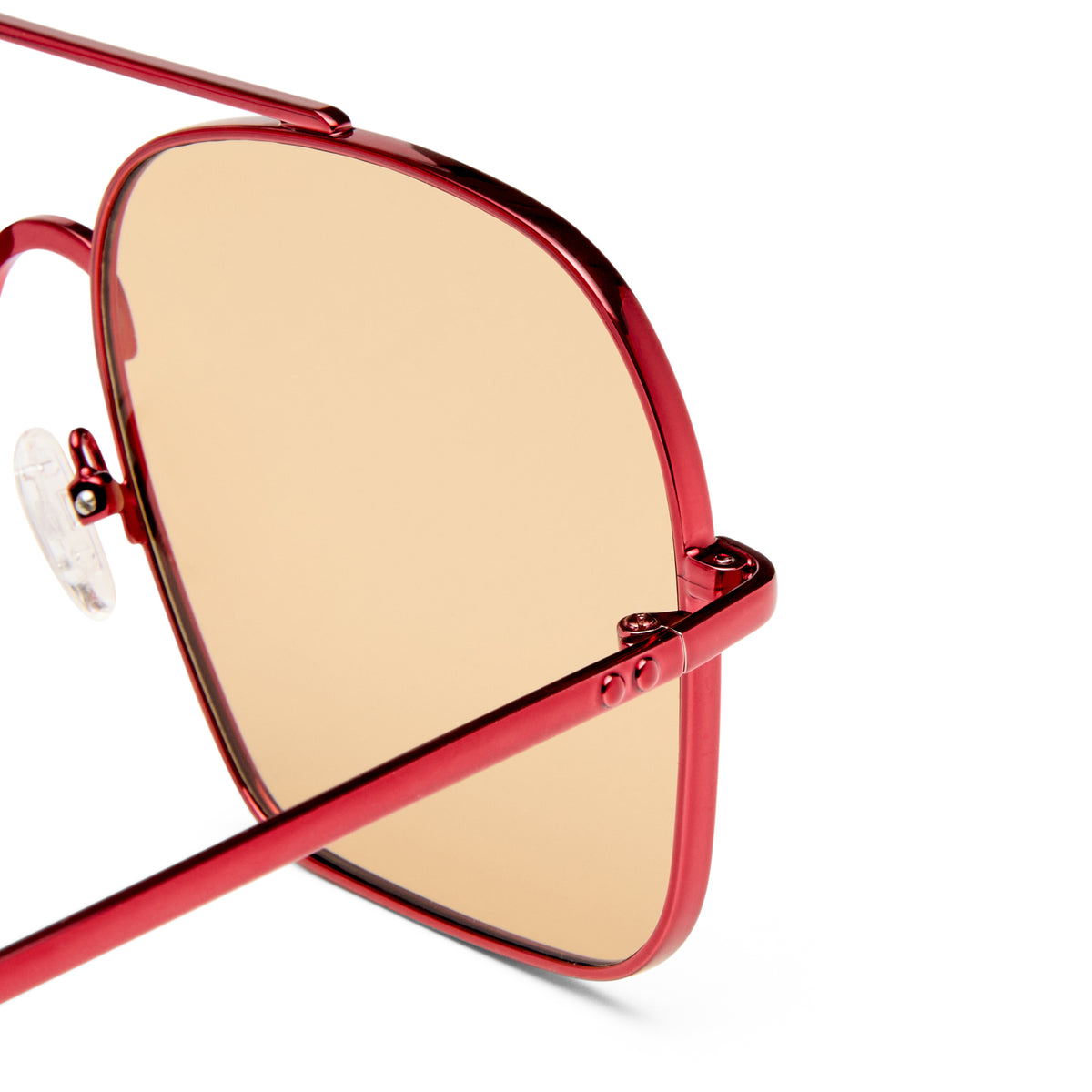 Red-framed sunglasses with gold-tinted lenses on a white background