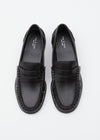 A pair of black leather penny loafers with braided detailing around the sole, photographed from a top-down perspective on a clean white background.