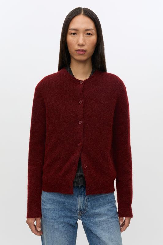 Woman wearing red cardigan on white background