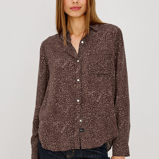 Woman wearing brown leopard print shirt