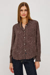 Woman wearing brown leopard print shirt