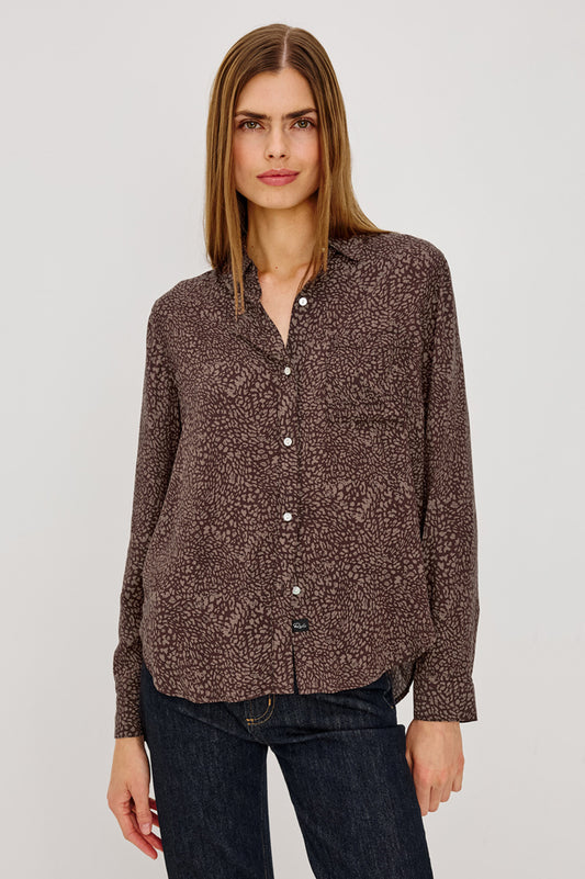 Woman wearing brown leopard print shirt