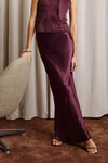 Woman wearing burgundy skirt and jumper