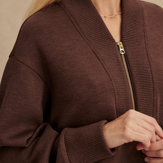 chocolate brown half zip jumper with dropped shoulder, rib detailing and gold zip close up