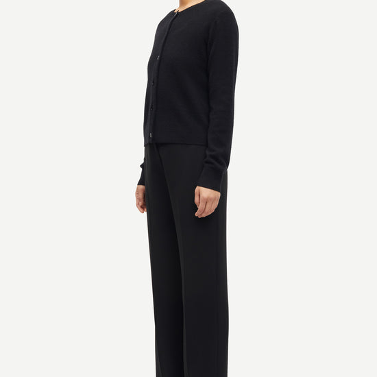 Person wearing a black outfit on a white background from Samsoe Samsoe