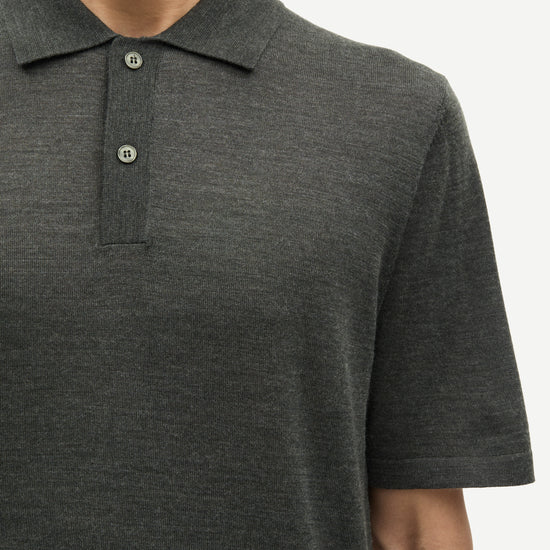 Dark green polo shirt worn by a person on a white background from Samsoe Samsoe