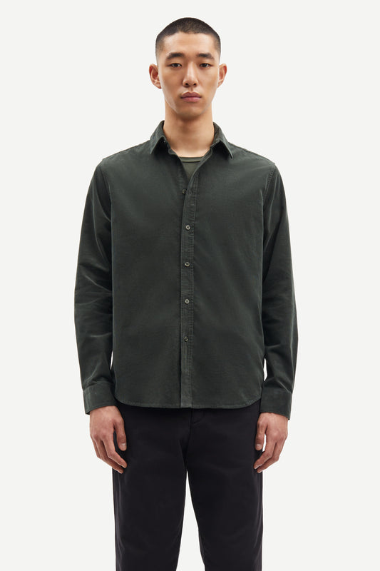 Man wearing a dark green button-up shirt over a gray t-shirt on a white background from Samsoe Samsoe