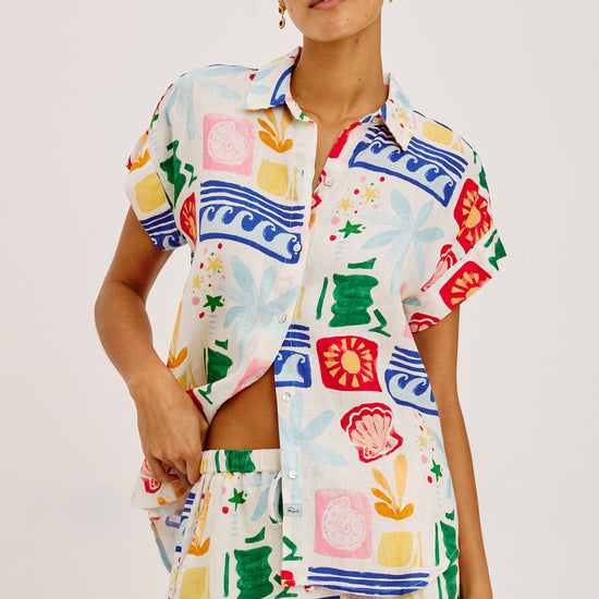 Woman wearing a colorful patterned outfit on a white background