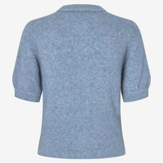 A light blue short-sleeve knit top shown from the back, featuring a ribbed hem and cuffs, on a plain off-white background.